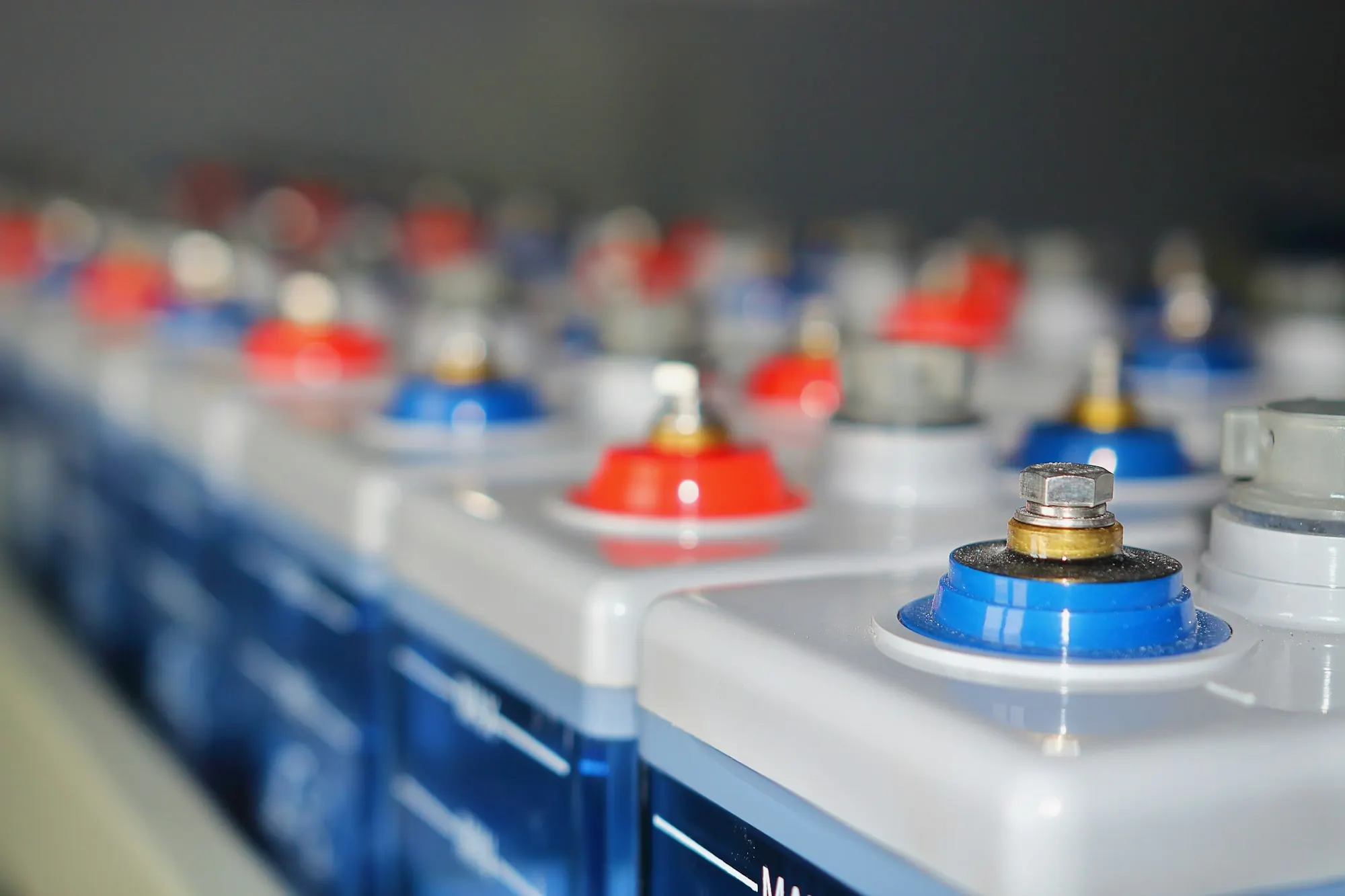 Rows of battery storage cells with red and blue terminals