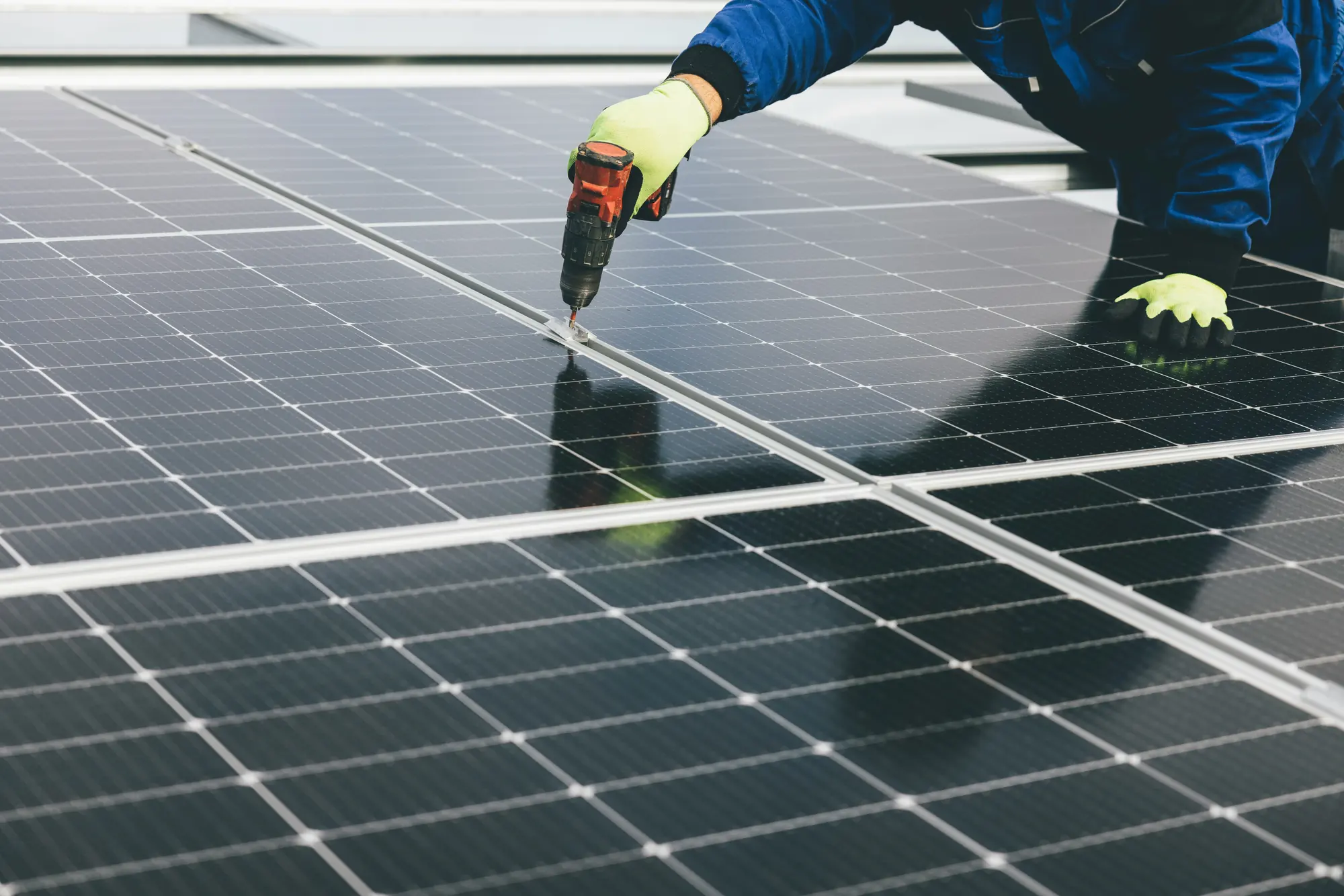 Installer securing solar panels during an AfyaSolar installation
