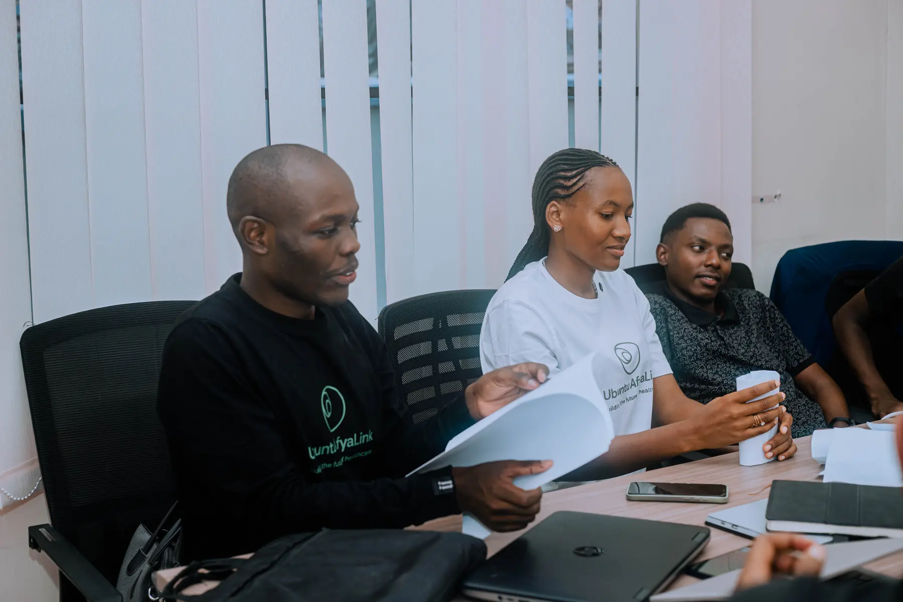 AfyaLink team reviewing documents in a meeting